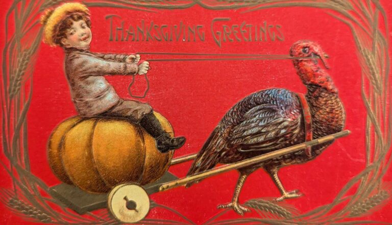 An image of a boy riding a pumpkin. The pumpkin has wheels and is being pulled by a turkey. The image has a red background.