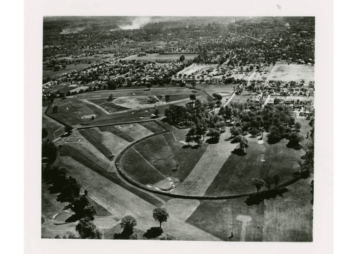 Black and white aerial photograph of an earthwork and town