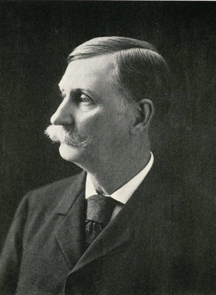 Black and white photograph of Henry Clay Taylor, 1900-1910. Shows him in profile in dark suit and tie. 